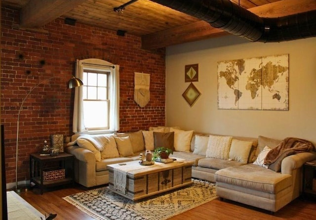 living room with wood finished floors, beam ceiling, wooden ceiling, and brick wall