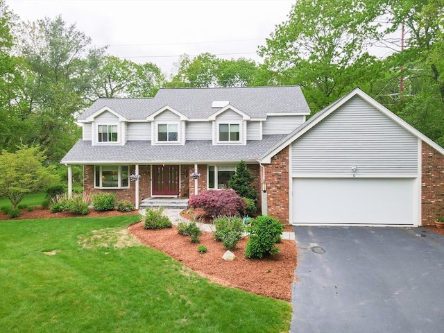 10 Grover Rd, Ashland, MA 01721 - traditional home featuring driveway, brick siding, an attached garage, a front yard, and roof with shingles