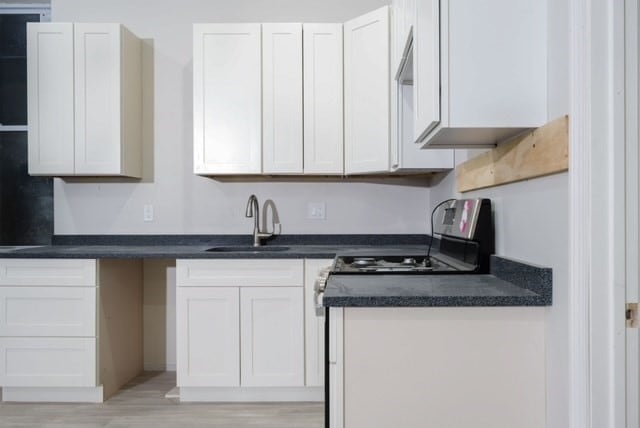 kitchen with white cabinetry and sink