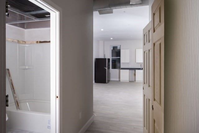 hallway with light wood-type flooring