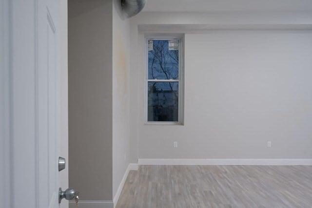 unfurnished room with light hardwood / wood-style floors