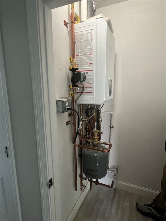 utility room with tankless water heater