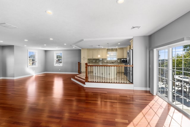 unfurnished living room with a textured ceiling and light wood-type flooring