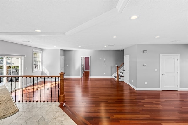 spare room featuring wood-type flooring and a textured ceiling