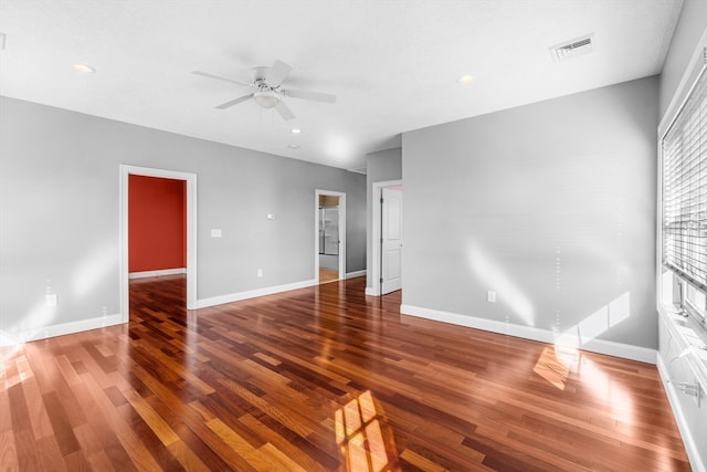 spare room featuring ceiling fan and dark hardwood / wood-style floors