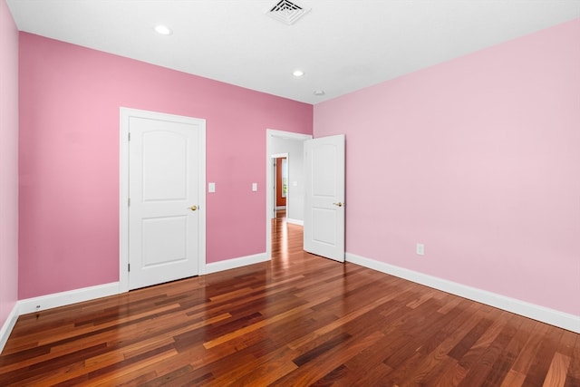 unfurnished bedroom with dark wood-type flooring