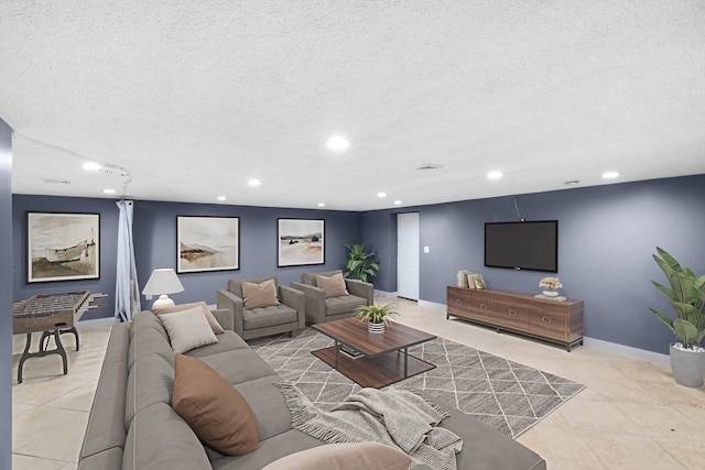 tiled living room featuring a textured ceiling