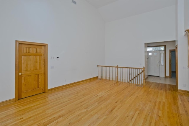 24 High Pines Cir Unit 24, Wilbraham, MA 01095 - spare room with high vaulted ceiling, light wood-style flooring, and baseboards