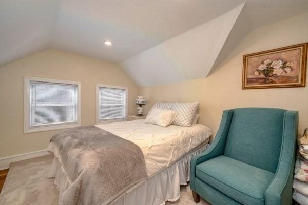 bedroom with vaulted ceiling and baseboards