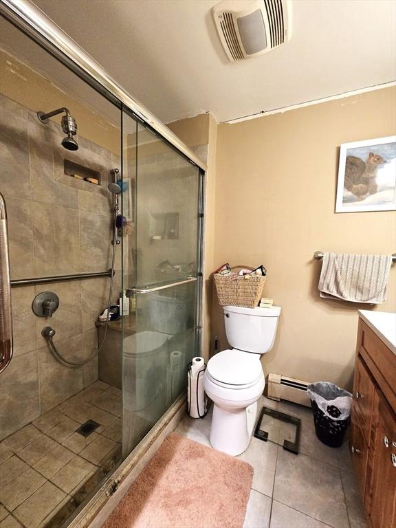 14 Many Oaks Cir, Yarmouth, MA 02675 - bathroom with a shower stall, vanity, tile patterned flooring, and a baseboard heating unit