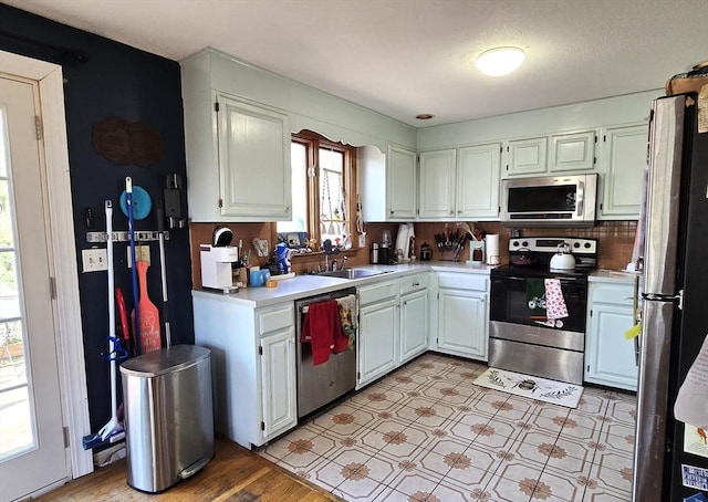 14 Many Oaks Cir, Yarmouth, MA 02675 - kitchen with appliances with stainless steel finishes, light countertops, white cabinets, and light floors