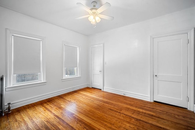 empty room featuring wood-type flooring and ceiling fan