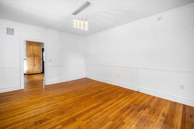 unfurnished room featuring crown molding and wood-type flooring