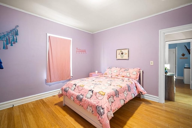 bedroom with crown molding and hardwood / wood-style floors