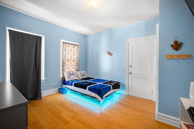 bedroom with hardwood / wood-style flooring