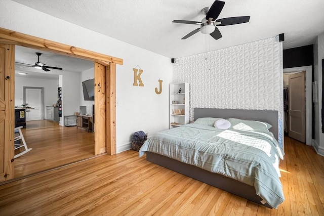 bedroom featuring hardwood / wood-style floors and ceiling fan