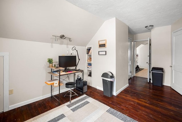 office area featuring lofted ceiling, dark hardwood / wood-style floors, and a textured ceiling