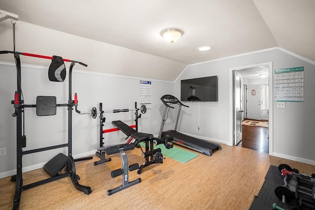 workout room featuring lofted ceiling and hardwood / wood-style floors