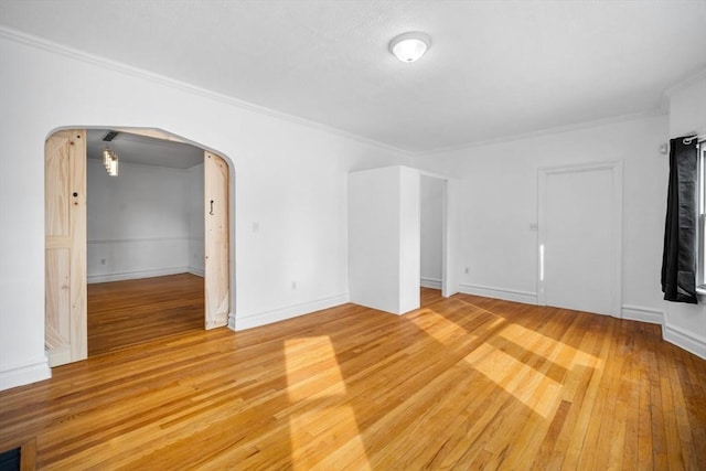 unfurnished living room featuring crown molding and hardwood / wood-style flooring