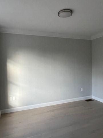 unfurnished room featuring ornamental molding