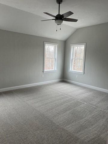 carpeted empty room with lofted ceiling and ceiling fan