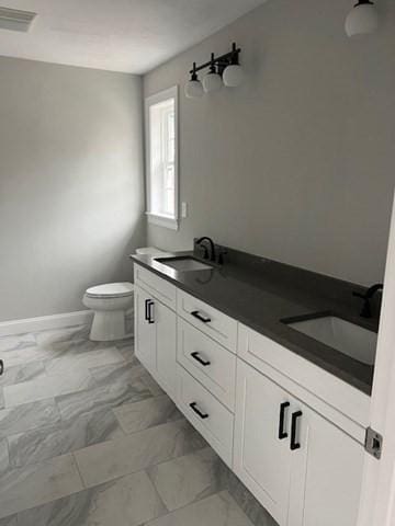 bathroom with toilet and vanity