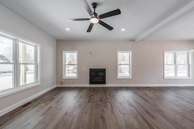 unfurnished living room featuring wood-type flooring and plenty of natural light