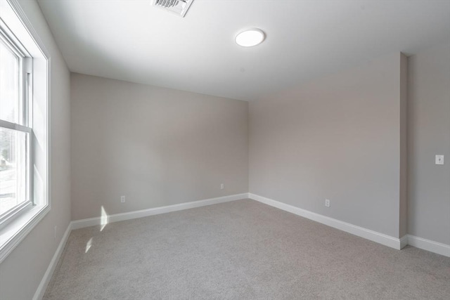 spare room with light colored carpet