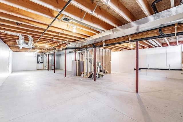 basement featuring heating unit and electric panel