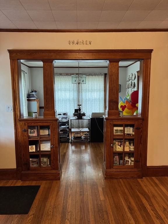 194 Fells Ave, Medford, MA 02155 - hallway featuring hardwood / wood-style flooring, decorative columns, baseboards, and crown molding