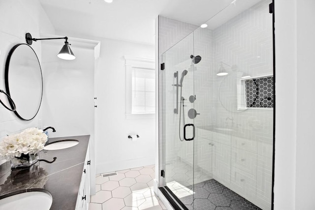 full bath with tile patterned floors, a stall shower, and double vanity