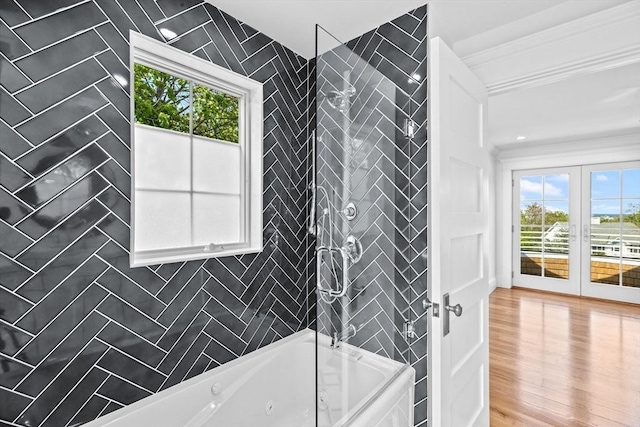 bathroom with ornamental molding, plenty of natural light, french doors, and a combined bath / shower with jetted tub