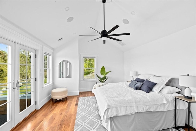 bedroom featuring access to outside, lofted ceiling, light wood finished floors, french doors, and baseboards
