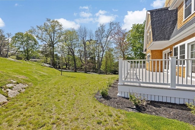 view of green lawn featuring a wooden deck
