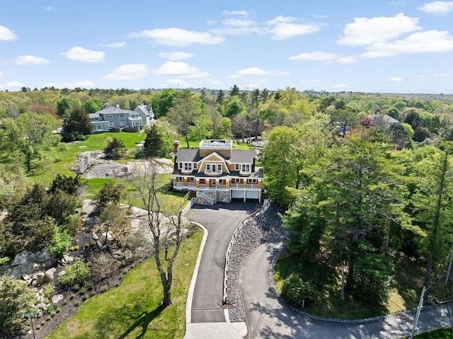aerial view of property's location featuring a heavily wooded area