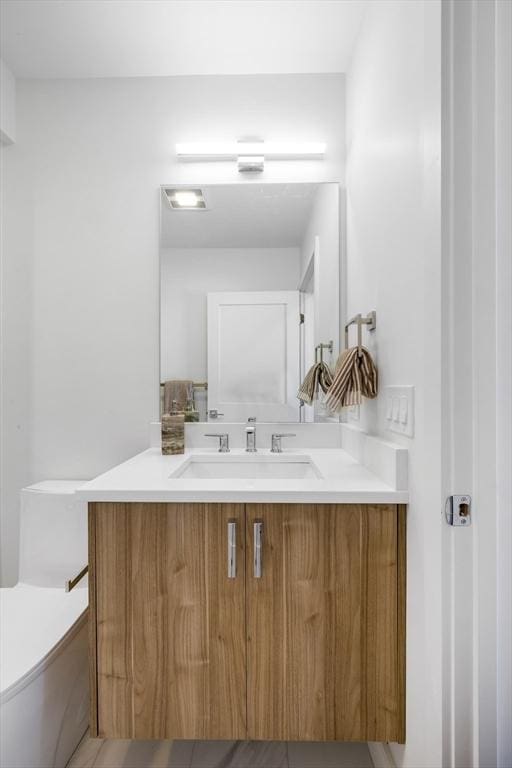 bathroom with vanity and toilet