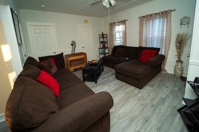 living room with crown molding, light hardwood / wood-style flooring, and ceiling fan