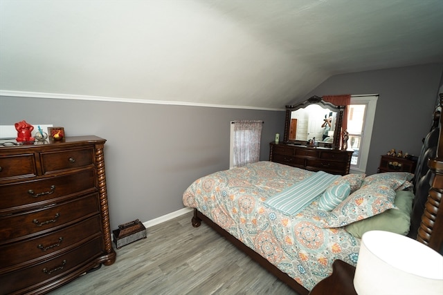 bedroom featuring lofted ceiling and wood-type flooring