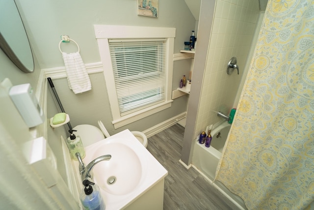 full bathroom with toilet, shower / bath combination with curtain, hardwood / wood-style flooring, and sink