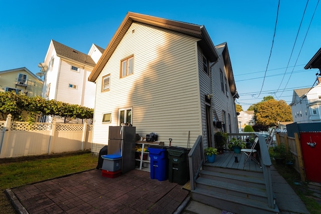 rear view of property featuring a patio and a deck