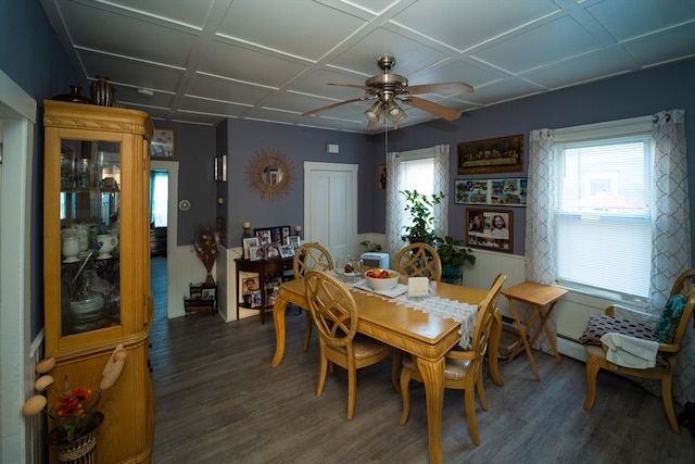 dining area with baseboard heating, dark wood-type flooring, and ceiling fan