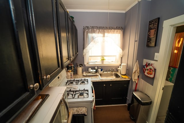 kitchen featuring ornamental molding, white gas range oven, and sink