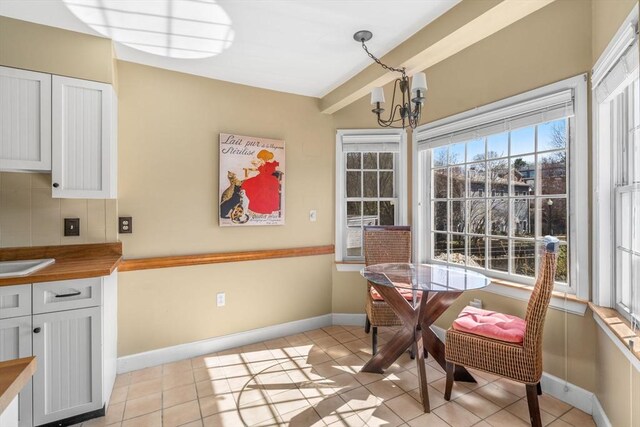 30 N Stone Ml Unit 1211, Dedham, MA 02026 - dining room with baseboards, light tile patterned flooring, and a notable chandelier