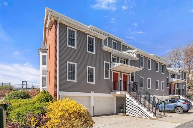 30 N Stone Ml Unit 1211, Dedham, MA 02026 - view of property with an attached garage, fence, and driveway