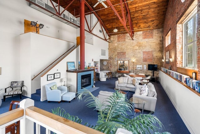 30 N Stone Ml Unit 1211, Dedham, MA 02026 - living area with beam ceiling, carpet floors, high vaulted ceiling, a tile fireplace, and wood ceiling