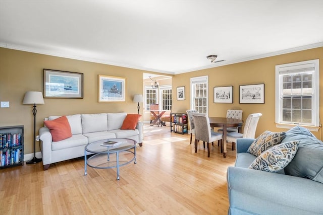 30 N Stone Ml Unit 1211, Dedham, MA 02026 - living area with crown molding, light wood-type flooring, plenty of natural light, and an inviting chandelier