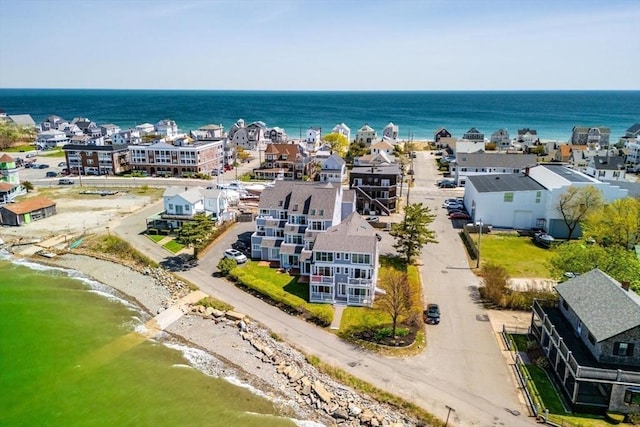 drone / aerial view featuring a water view and a view of the beach