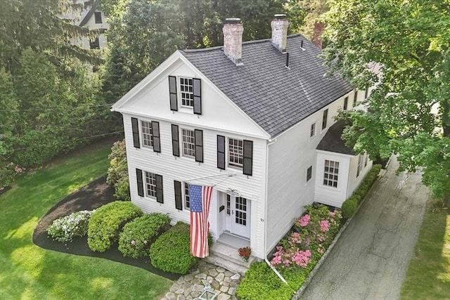 57 Highland St, Holden, MA 01520 - view of front of home featuring a chimney, roof with shingles, and a front lawn