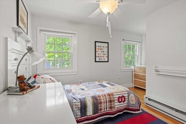 57 Highland St, Holden, MA 01520 - bedroom featuring a baseboard heating unit, wood finished floors, ceiling fan, and baseboards