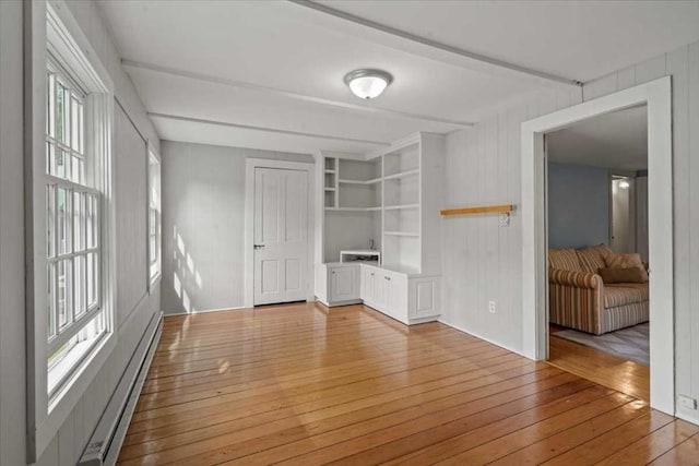 57 Highland St, Holden, MA 01520 - unfurnished room with light wood-style flooring, a baseboard heating unit, beamed ceiling, built in features, and wooden walls